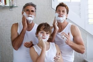 grandfather, father and son applying shaving cream --- Image by © Ole Graf/Corbis